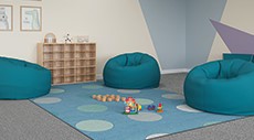 A classroom with a bean bag chair and rug.